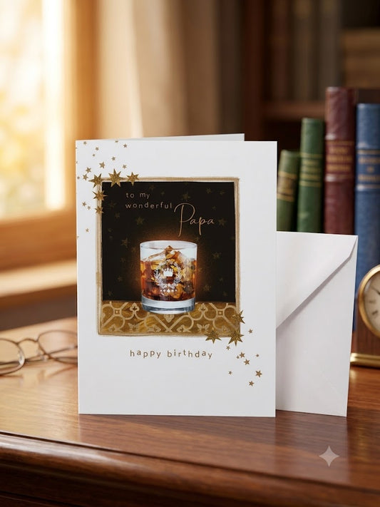To My Wonderful Papa Happy Birthday card — gold stars and whisky tumbler design, warm lifestyle photo with books
