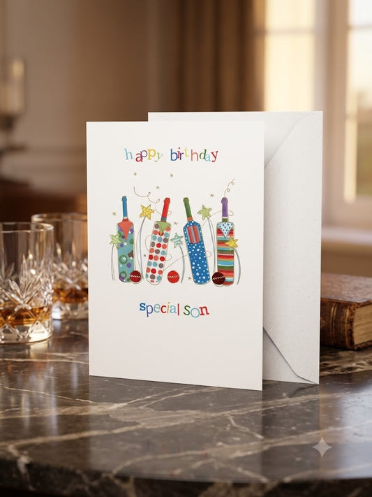 Happy Birthday Special Son cricket card — colourful illustrated cricket bats and stars, dark marble lifestyle photo with whisky glasses