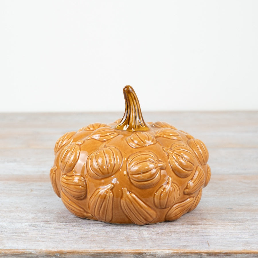 Glazed ceramic pumpkin ornament with all-over embossed miniature pumpkin relief pattern and sculptural stem