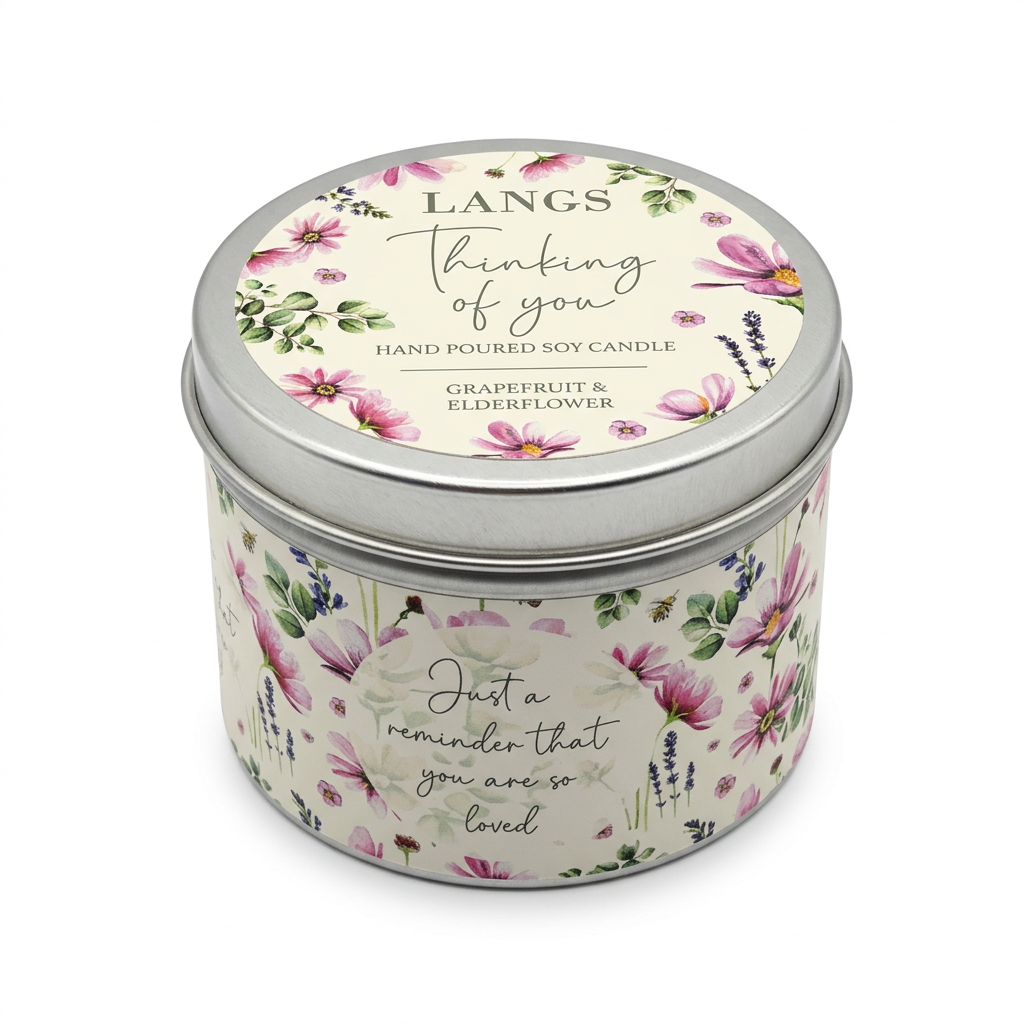 Langs Thinking of You Grapefruit & Elderflower candle tin with pink floral decoration and a closed silver-rimmed lid on a white background.