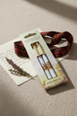 Highland Coo twin pen set by Jan Pashley styled with a handwritten letter and sprig of heather on a linen surface