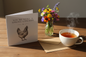 You're Still A Spring Chicken card standing open in a cosy lifestyle setting