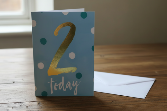 2 Today blue polka dot birthday card standing upright spine-left slightly open in a cosy lifestyle setting