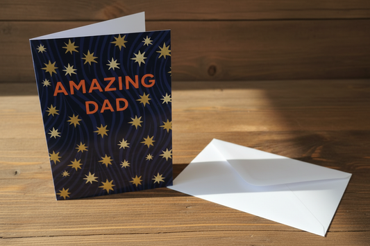 Amazing Dad stars card standing upright spine-left slightly open in a cosy lifestyle setting