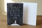 Starry night sympathy greeting card lifestyle photo on rustic wooden surface with white envelope, spine on left