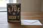 70 and Rockin' It birthday card standing upright spine-left slightly open in a cosy lifestyle setting