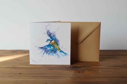Blue tit watercolour card standing upright spine-left slightly open in a cosy lifestyle setting