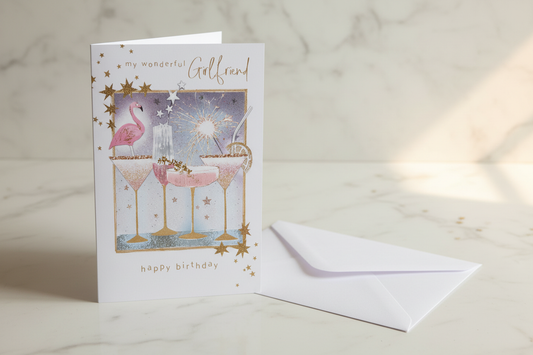 My Wonderful Girlfriend birthday card with flamingo and cocktail glasses standing upright in a premium lifestyle setting