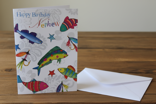 Happy Birthday Nephew fish card standing upright spine-left slightly open in a cosy lifestyle setting