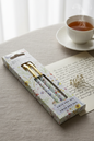 Wings & Wildflowers twin pen set by Jan Pashley styled with a handwritten letter and dried flowers on a linen surface