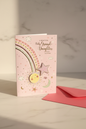 Baby Grand-Daughter card lifestyle shot – upright with pink envelope, warm natural light