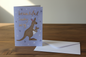 Beautiful Baby Boy greeting card lifestyle photo on rustic wooden surface with white envelope