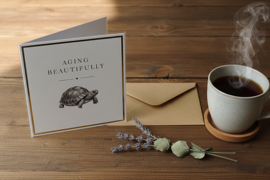 Aging Beautifully tortoise card standing open spine-left in a cosy lifestyle setting