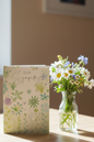 With Sympathy wildflower card lifestyle image on wooden desk