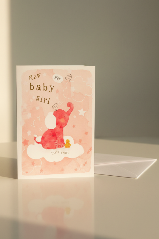 New Baby Girl card lifestyle shot – upright with white envelope, warm natural light
