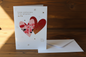 Happy Anniversary wife card standing upright spine-left slightly open in a cosy lifestyle setting