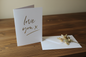 Love You X gold foil card standing upright spine-left slightly open in a cosy lifestyle setting